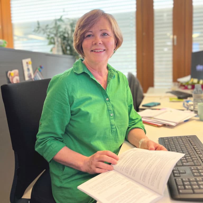 Renate Huber at her desk